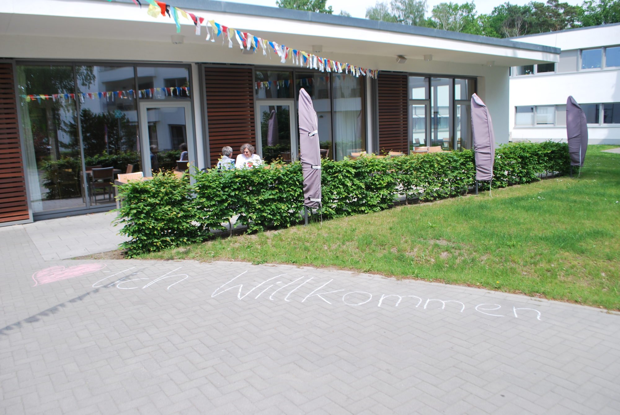 Das P.A.N. Zentrum von außen. auf dem Boden steht mir Kreide geschrieben: Herzlich Willkommen.